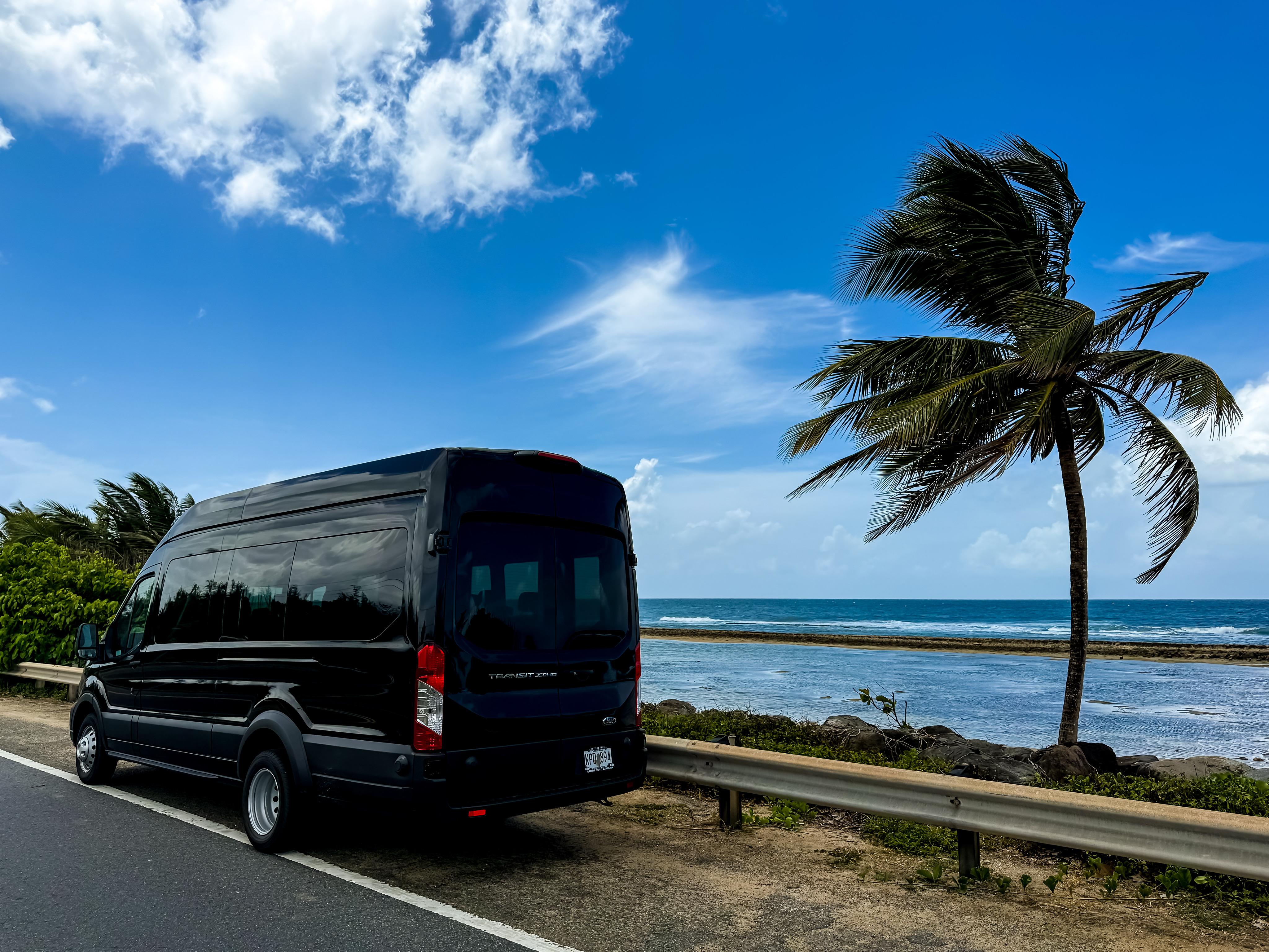 Premier Transportation van parked beside a Puerto Rico beach